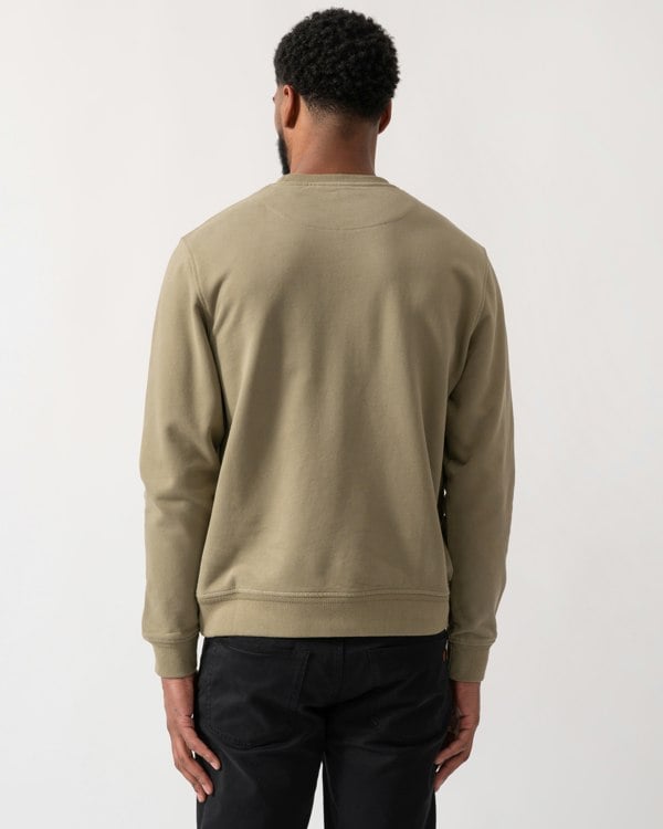 back shot of a model wearing a Belstaff Mens Crew Neck Sweatshirt With Logo Patch in Fatigue Green