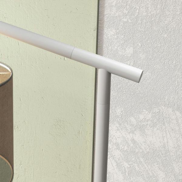 Close-up of white metal lamp pole with angled arm and joint