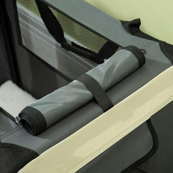 Close-up of folded cushion insert with elastic strap on a grey foldable pet carrier