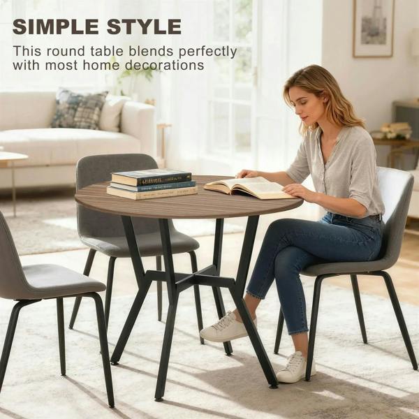 Round brown dining table with black legs, smooth wood top for seating