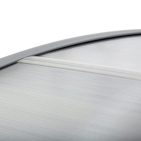 Close-up of clear ribbed polycarbonate canopy panel with gray edge trim and frame
