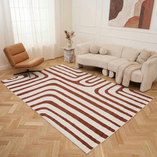 Living room with a striped rug, beige sofa, and brown chair.