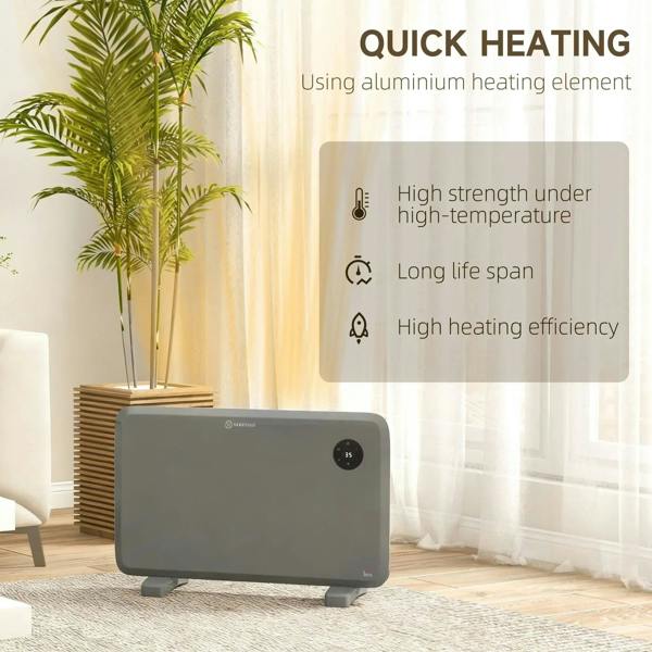 Grey electric convector heater with round control dial, placed on the floor