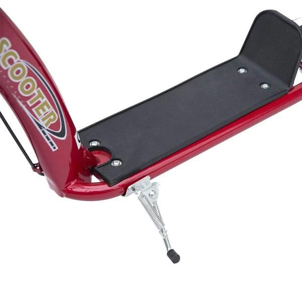 Red kick scooter close-up of black foot deck and rear kickstand