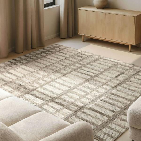 Patterned rug on a wooden floor with a sofa and cabinet in a room.