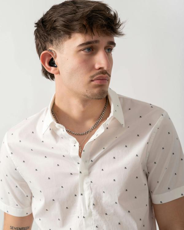 close up shot of a model wearing an Armani Exchange Mens Short Sleeve Shirt with Geometric Pattern in Off White F0198