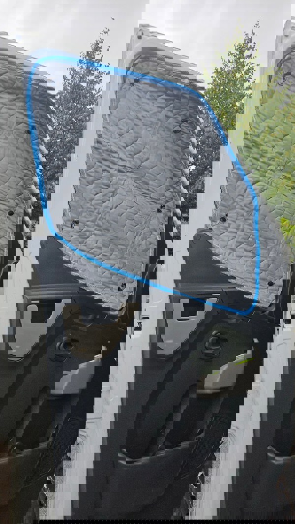 Internal Thermal Blind Set (Renault Master, Vauxhall Movano, Nissan Interstar/NV400) by OLPRO pictured on the side door window fitted with the door open.