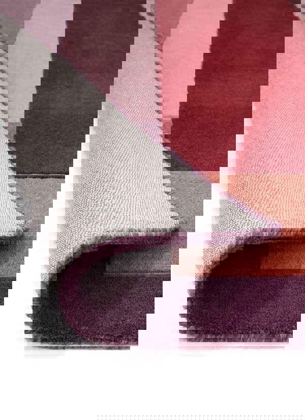 Corner view of a multicolour hand-carved geometric rug showcasing cut and loop pile texture.