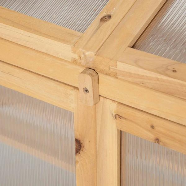 Close-up of wooden corner joint on cold frame greenhouse with clear polycarbonate