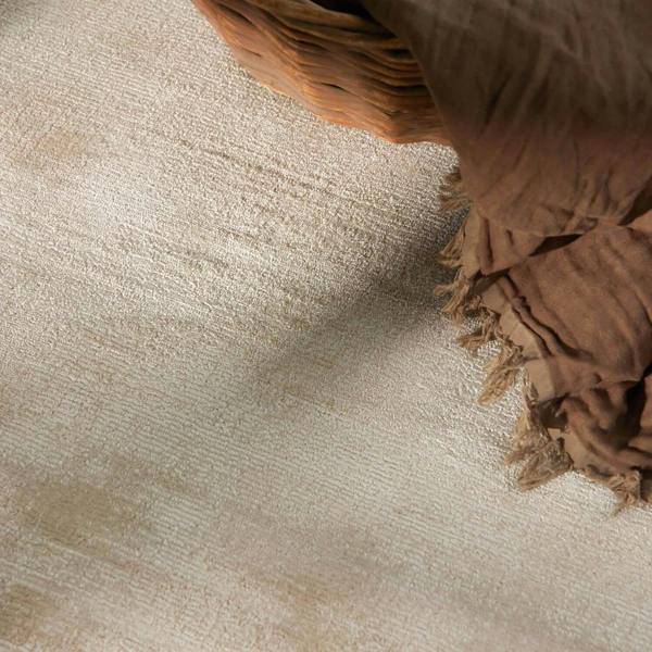 Brown woven basket on a textured beige surface