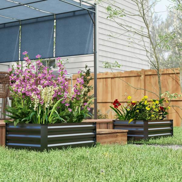 Dark grey steel raised planter box set with purple flower blooms and greenery