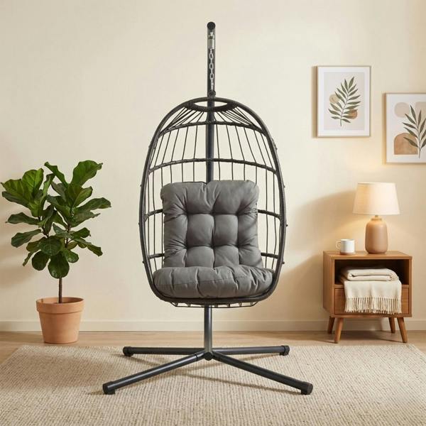 Stylish black rattan hanging egg chair with plush gray cushion, suspended from a sleek metal frame, perfect for indoor relaxation