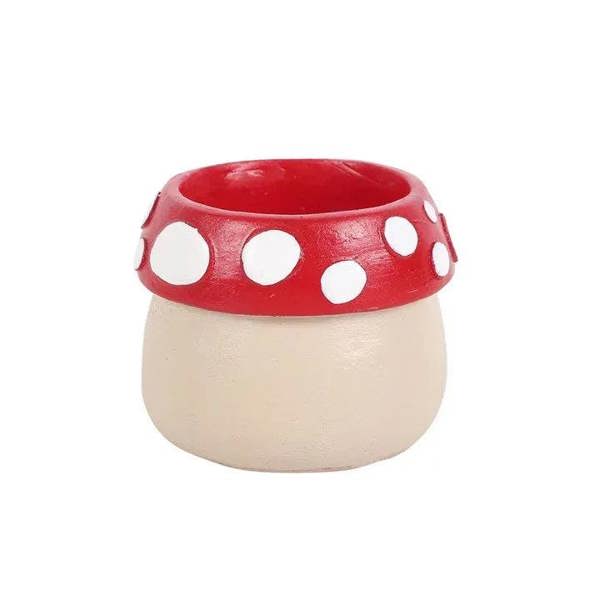 Mushroom house resin tealight holder, side view: red polka-dot band and cream base