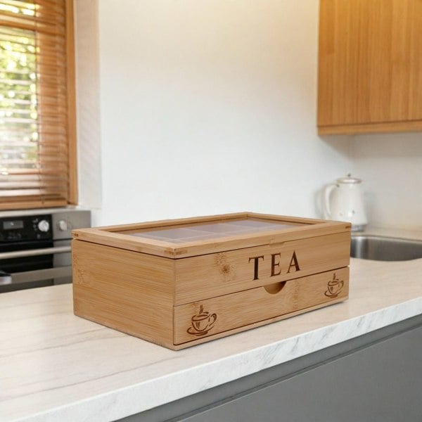 Wooden tea box with 'TEA' on a kitchen counter