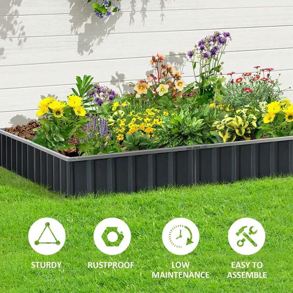 Long dark gray metal raised garden bed filled with colorful flowers on a lawn