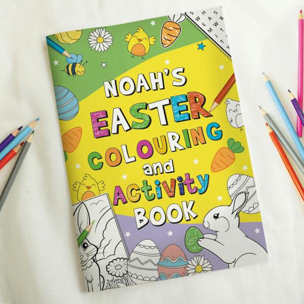 A personalised Easter colouring and activity book titled "Noah's Easter Colouring and Activity Book" lying on a white surface, surrounded by several coloured pencils.