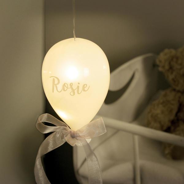 A frosted white light up glass balloon hanging decoration engraved with the script name Rosie.