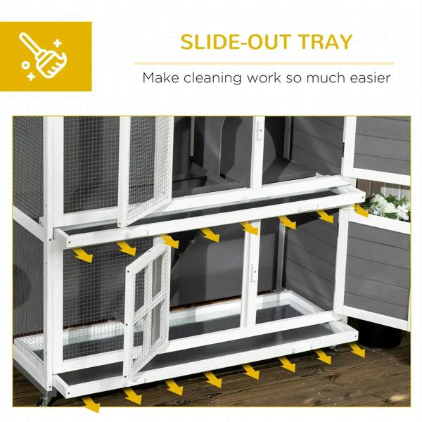 Two-tier rabbit hutch with slide-out tray pulled out beneath the wire mesh enclosure
