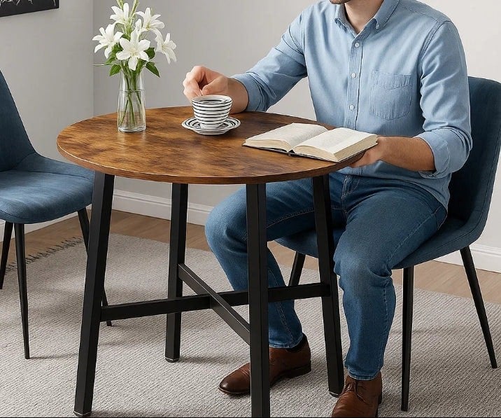 Industrial round dining table with rustic brown top and black steel frame, ideal for kitchen or office use

