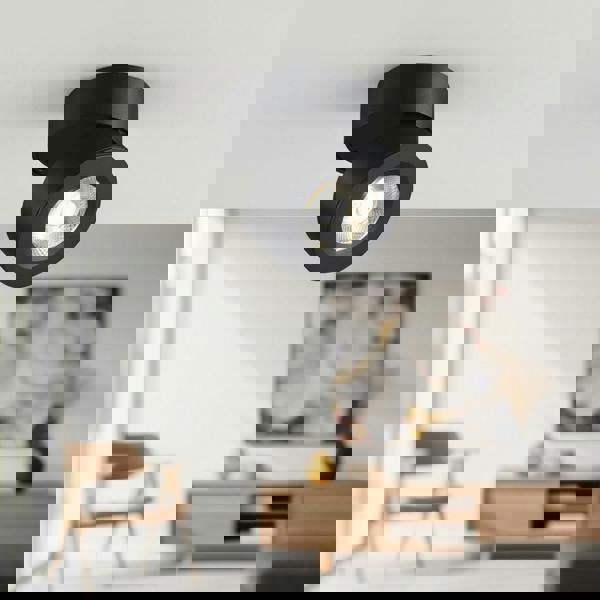 black adjustable surface mounted downlight installed on the ceiling in a house