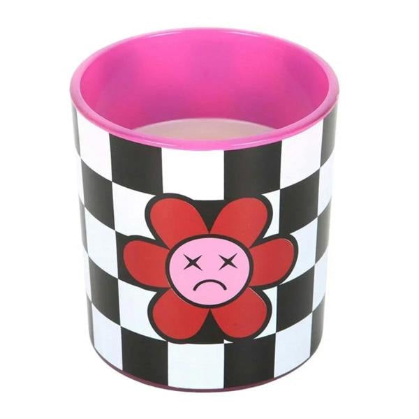 Close-up of checkered scented candle tin with red flower face and pink inner wax