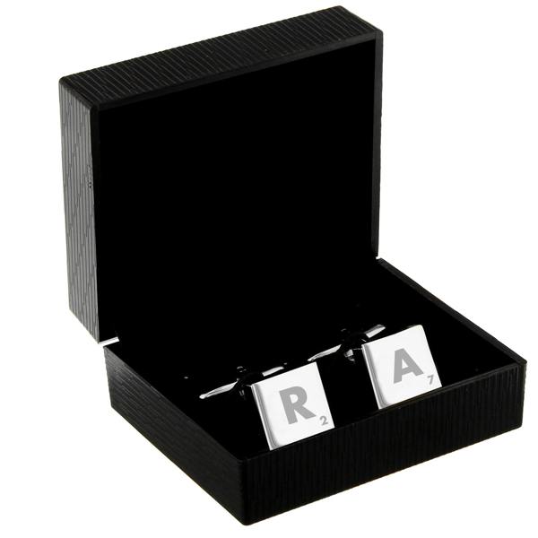 Pair of silver square initial cufflinks presented inside a luxury black textured gift box.