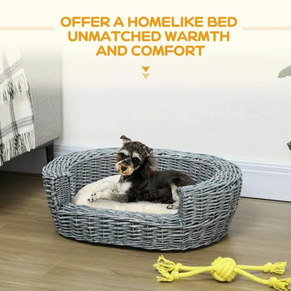 Grey wicker oval pet bed with beige cushion, dog resting inside