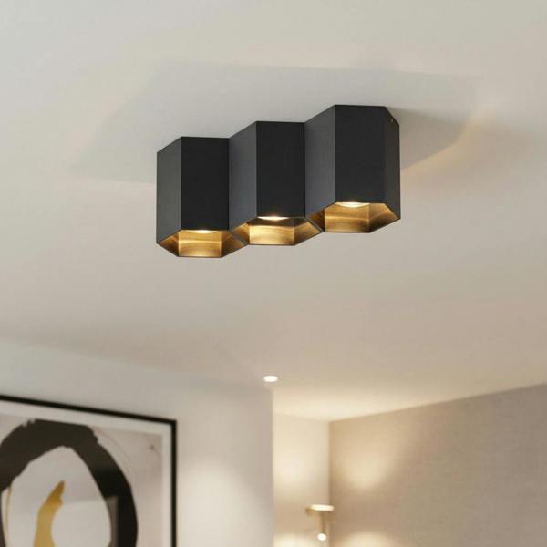 black flush ceiling lamp mounted on the ceiling in a hotel lounge