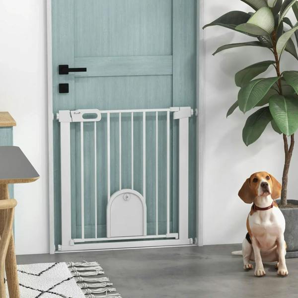 White pet safety gate with arched cat door, with dog sitting nearby