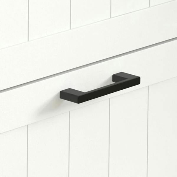 Close-up of black bar handle on white drawer front of a shoe storage cabinet