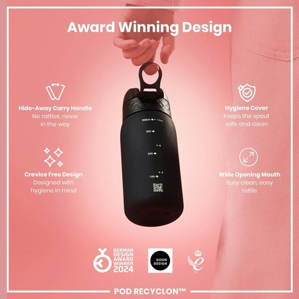 A black water bottle with a carrying handle is being held. The bottle features measurement markings and a QR code. It's shown against a pink background with text highlighting its design features and awards.