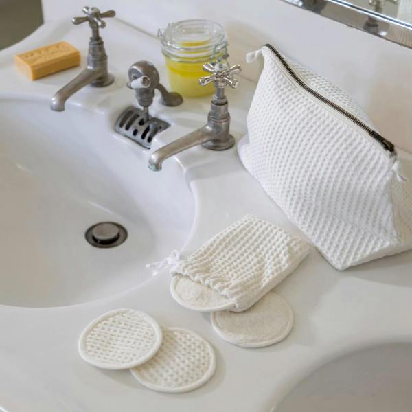 Ecru Waffle Cotton Re-Usable Face Pads styled in a bedroom | Soak and Sleep