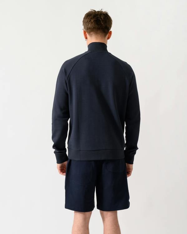 back shot of a model wearing a BOSS Green Sweat Mens quarter Zip Sweatshirt in Dark Blue 402