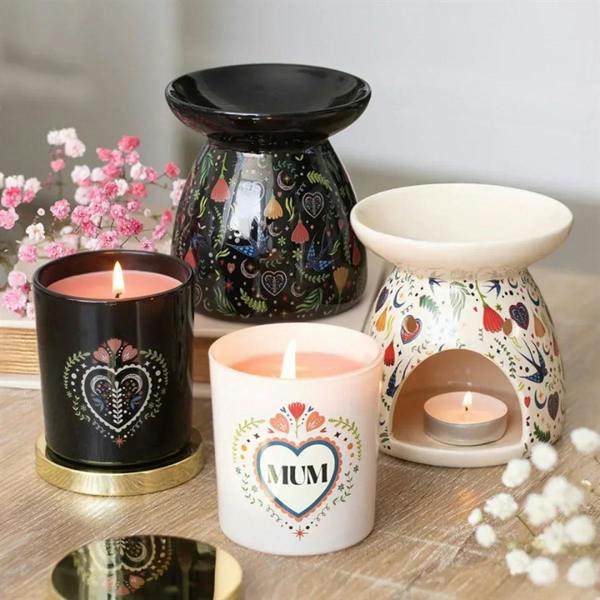 Assorted MUM heart candles in black and white jars with floral heart designs.