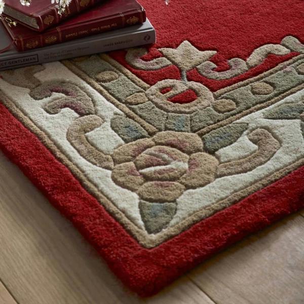 Decorative rug with intricate patterns on a wooden floor