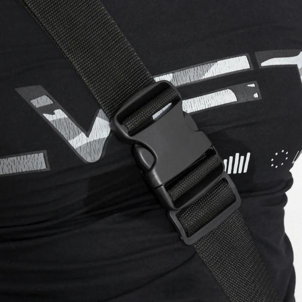 Safety belt strap and buckle on red/black inversion table, close-up