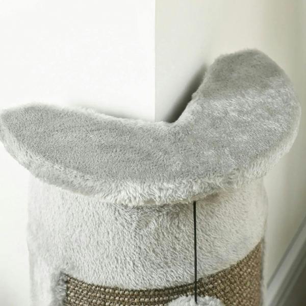 Grey plush cat scratching arm on top section above sisal rope panel