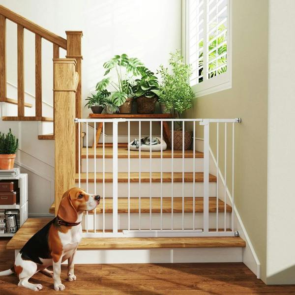 White pet safety gate installed at the top of a staircase