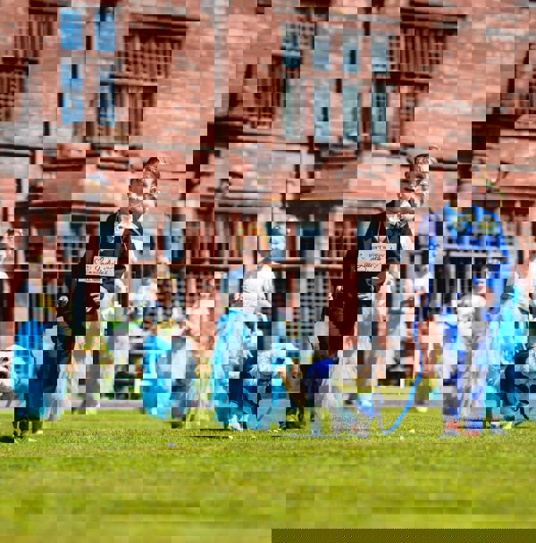 Flower girl and page boy party holding small dog