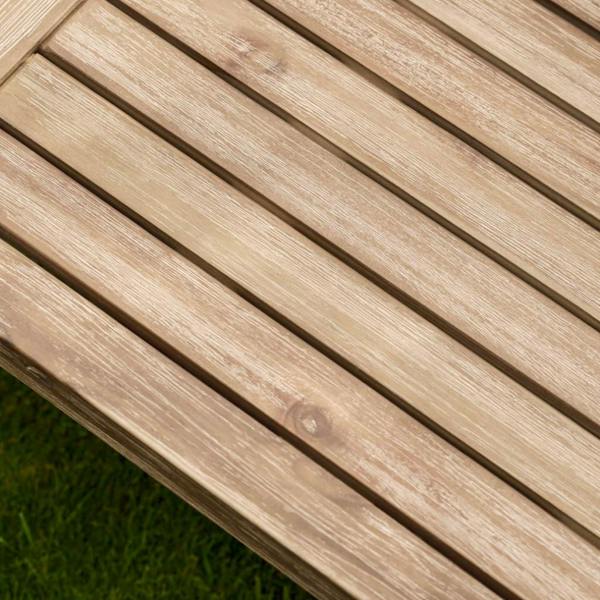 Close-up detail of the sturdy leg joint and weathered oil finish on a square acacia garden table.