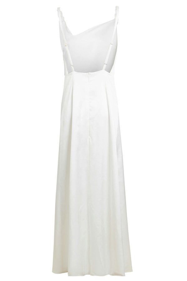 An Asymmetric White Maxi Dress by Sarvin with straps and buttons.