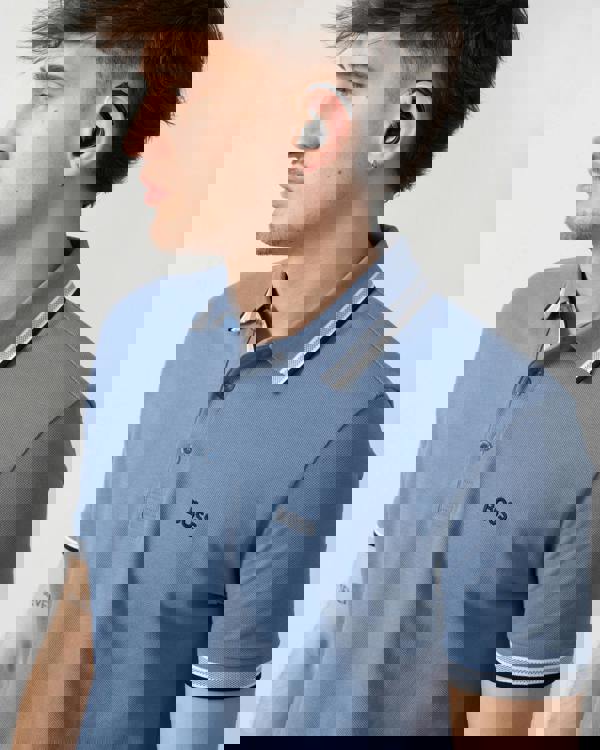 close up shot of a model wearing a BOSS Green Paddy Mens Cotton-Piqué Polo Shirt with Contrast Logo in Open Blue 462