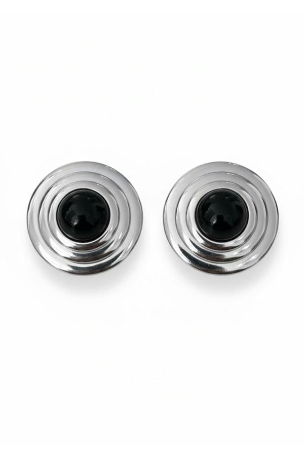 Silver earrings with a black centre on a white background