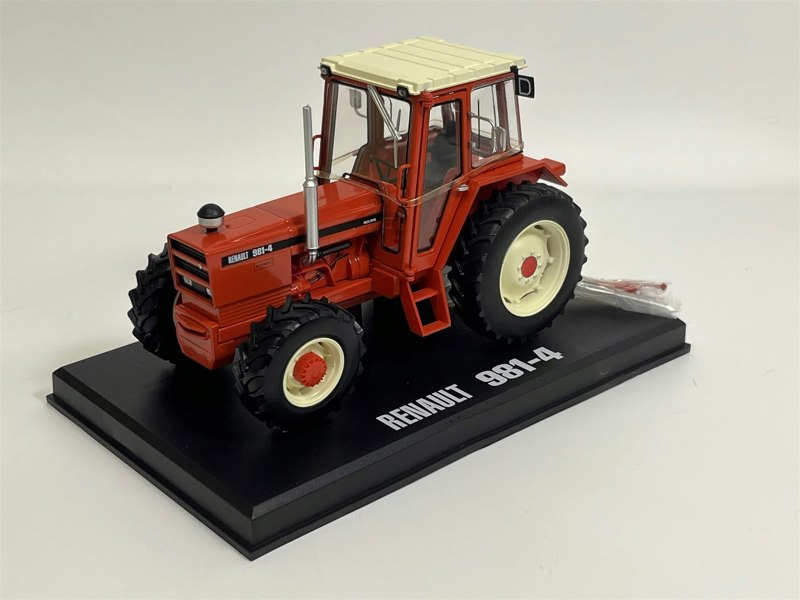 a red tractor on a black stand