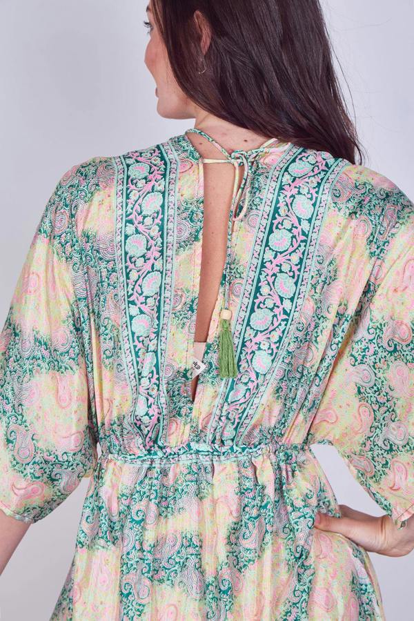 Woman wearing a floral dress with a plain background