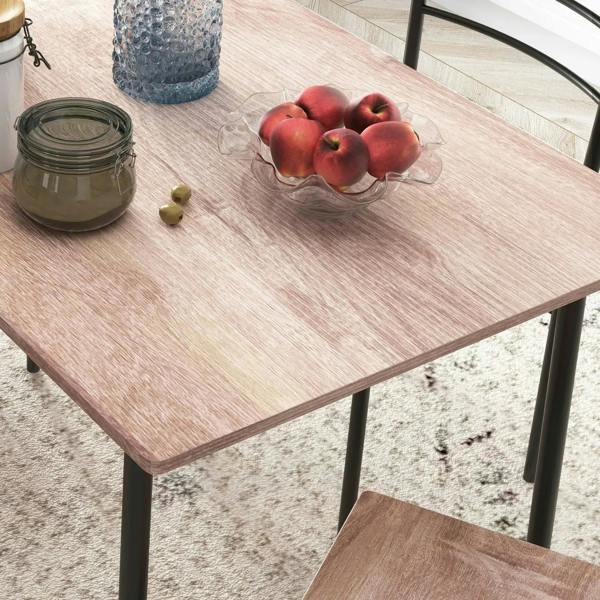 Wood-look dining tabletop with black metal legs; close-up with decorative centerpiece