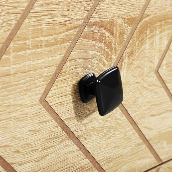 Natural wood dresser with black knob handle on zigzag-patterned drawer front.