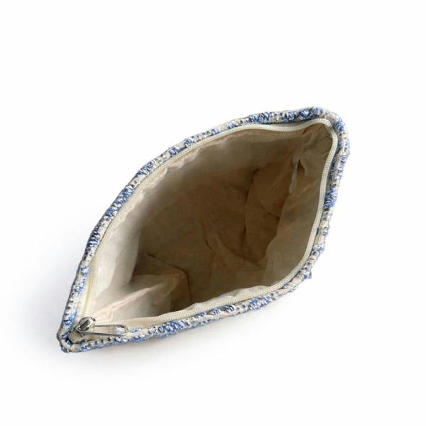 Indigo jacquard toiletry bag open to show beige lining and zip opening