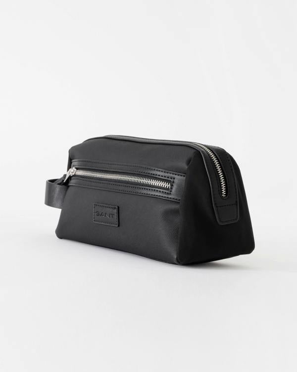 Black toiletry bag with zippers on a white background