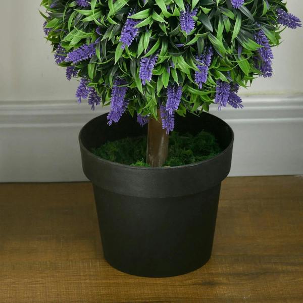 Black planter pot holding artificial lavender ball tree, with green leaves and purple blossoms
